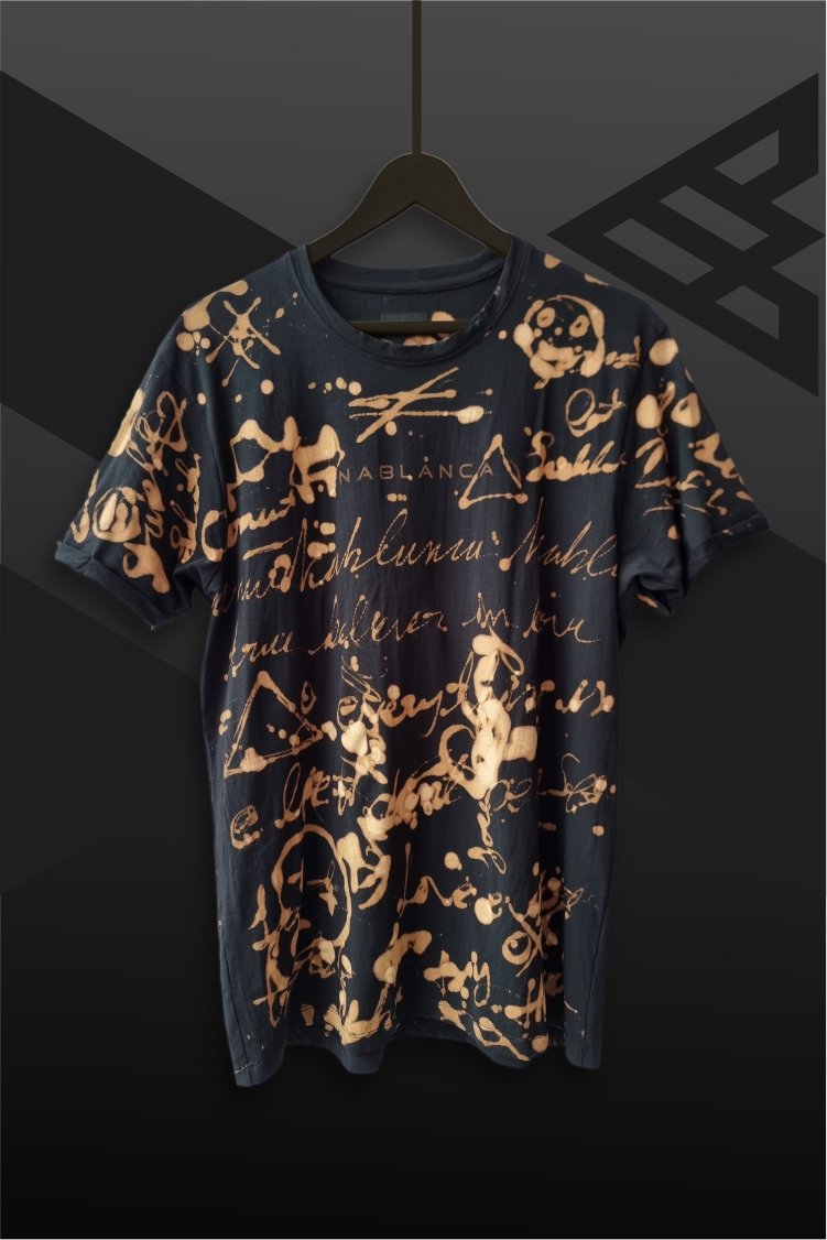 an image of a black t-shirt with copper colored handwriting graphics over it