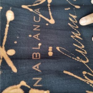 an image of a black t-shirt with copper colored handwriting graphics over it