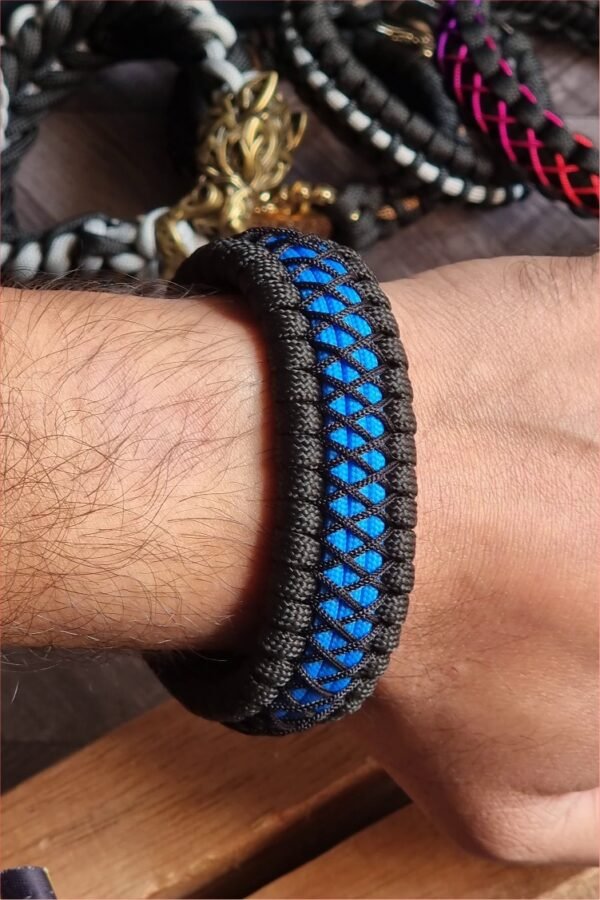 handmade survival paracord bracelet made of black, light blue paracords with shackle buckle