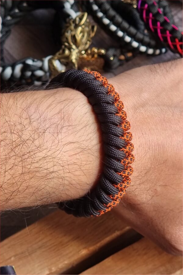 handmade paracord bracelet made with orange camo and black paracord 550 with shackle buckle