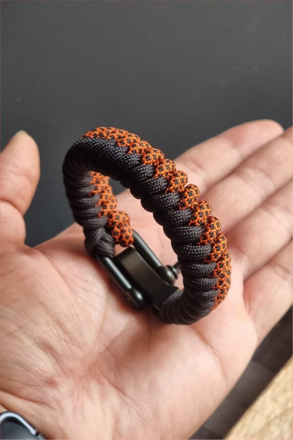 handmade paracord bracelet made with orange camo and black paracord 550 with shackle buckle