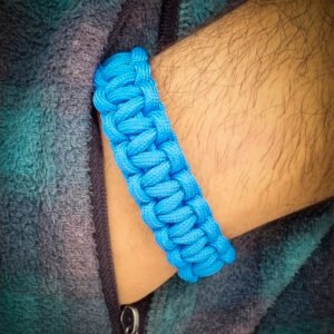 handmade stitched adjustable light blue paracord bracelet which resembles Tom Hardy's paracord bracelet from the movie Mad Max Fury Road