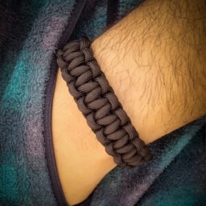 handmade stitched adjustable black paracord bracelet which resembles Tom Hardy's paracord bracelet from the movie Mad Max Fury Road