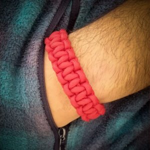 handmade stitched adjustable red paracord bracelet which resembles Tom Hardy's paracord bracelet from the movie Mad Max Fury Road