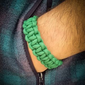 handmade stitched adjustable green paracord bracelet which resembles Tom Hardy's paracord bracelet from the movie Mad Max Fury Road