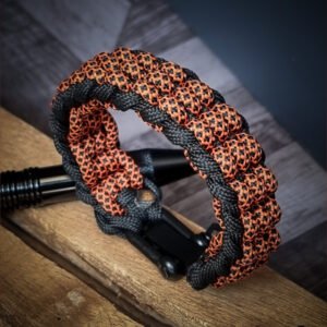 premium handmade track knot paracord bracelet in diamond orange and black paracord with adjustable shackle buckle