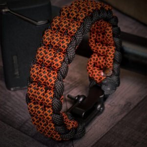 premium handmade track knot paracord bracelet in diamond orange and black paracord with adjustable shackle buckle