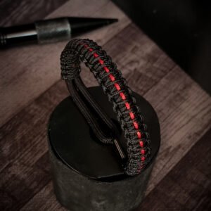 Paracord bracelet with micro-cord stitching with thin red line style