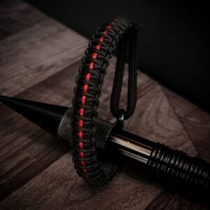 Paracord bracelet with micro-cord stitching with thin red line style