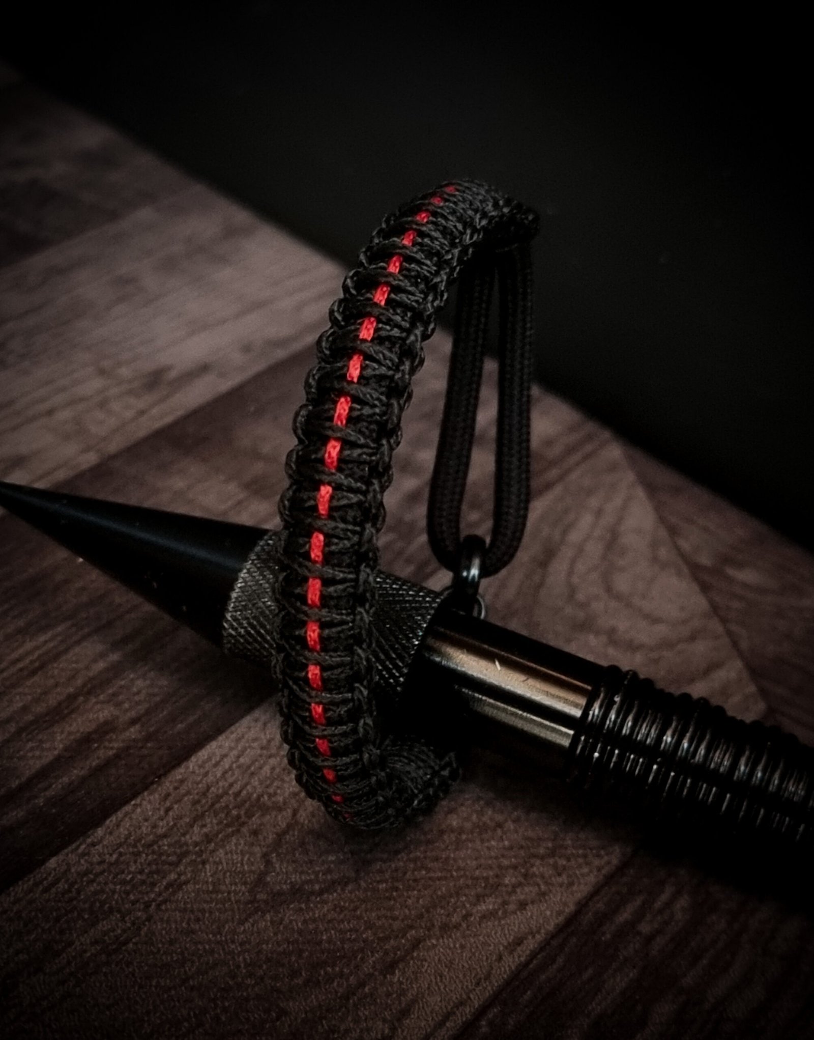 Paracord bracelet with micro-cord stitching with thin red line style