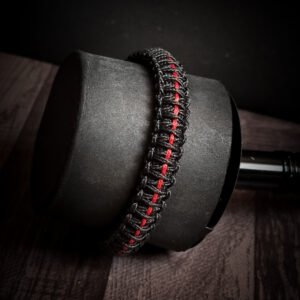 Paracord bracelet with micro-cord stitching with thin red line style