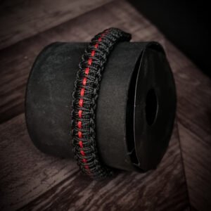 Paracord bracelet with micro-cord stitching with thin red line style